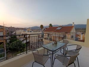 a table and chairs on a balcony with a view at Apagio Suite in Argostoli
