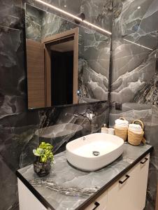 a bathroom with a sink and a mirror at Apagio Suite in Argostoli