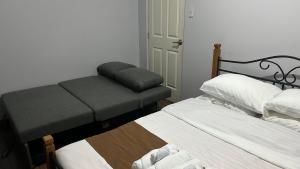 a bedroom with two beds and a foot stool at Condo Unit at La Verti Residences in Manila +16 photos