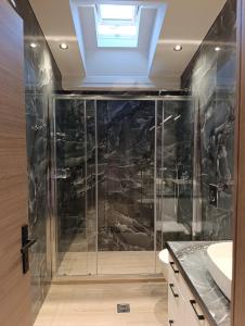 a bathroom with a shower with a glass wall at Apagio Suite in Argostoli +20 photos