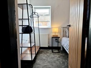 a room with a ladder next to a bed at Super Stylish and Vibrant 3 Bed Getaway in Hull +32 photos