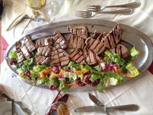 a plate of food with a salad on a table at Hotel Da Attilio in Sapri