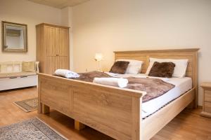a bedroom with a large wooden bed with two pillows at Hiša Elsbacher Laško in Laško