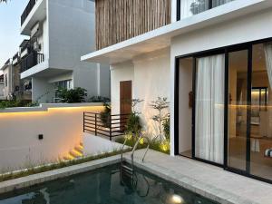 a house with a swimming pool in front of it at Dreamland View Villa #3 with Pool in Uluwatu