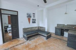 a living room with a bench in the middle of a room at REZ SPACE Apartment 06 in Hiriketiya