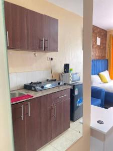 a kitchen with a sink and a stove in a room at Aheri Homes in Ruaka