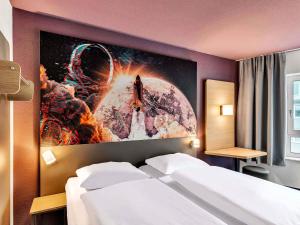 a hotel room with a poster of a space station at B&B Hotel Bremen-Altstadt in Bremen