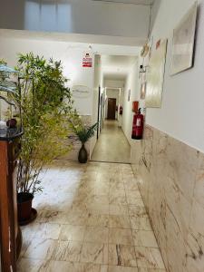 a hallway in a building with plants on the walls at Residencial Pimenta ,Portimao,Algarve in Portimão