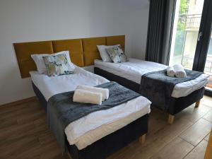 Postel nebo postele na pokoji v ubytování FLAUTA apartamenty