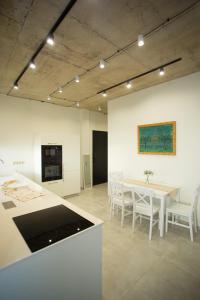 a kitchen with a table and chairs in a room at Sea View Boutique Apartments in Chakvi