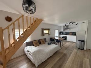 a living room with a bed and a staircase at La Rêverie in Le Thor