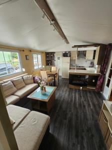 a living room with a couch and a table at Entre Terre et Mer in Le Tréport