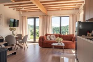 a living room with a couch and a table at Wichrowy Domek in Nowy Targ