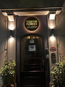 a sign above the door of a hotel entrance at JOIVY Together Florence Secret Nest in Florence