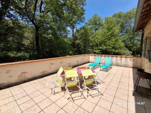 three chairs and a table on a patio at Gites Villa Robinson in Mazamet