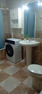 a bathroom with a washing machine and a sink at Casa MªÁngeles in Puebla de Arenoso