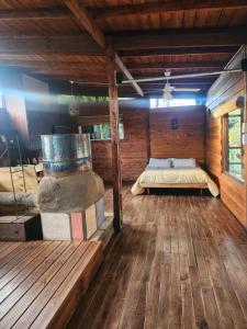 a bedroom with a bed in a wooden cabin at Cabaña el colibri in Mar del Plata
