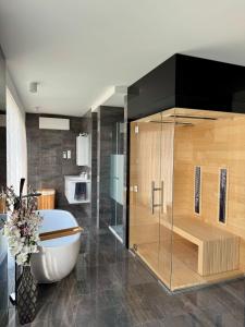 a bathroom with a tub and a toilet in a room at Villapark apartman A-B 12 in Fonyód