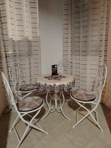 a table and chairs with a laptop on top of it at Castelo 2025 in Vrnjačka Banja +15 photos
