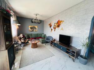 a living room with a couch and a tv at Caldera Premium Villa in Kavala +30 photos