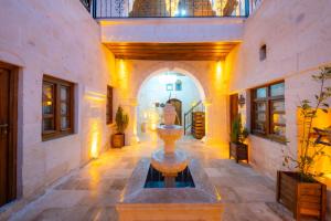 a room with a fountain in the middle of a building at AURA TAŞ Hotel in Urfa