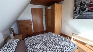 a bedroom with a bed and a dresser and a cabinet at Ferienwohnung Hermann Fliessau Zernien in Zernien