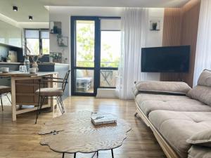 a living room with a couch and a table at River view Kardzhali in Kŭrdzhali +18 photos