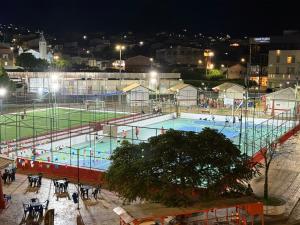 a large swimming pool at night with people in it at Hotel Real Jequie in Jequié