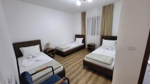 a hotel room with two beds and a couch at Dragobia House & Table in Dragobi +10 photos