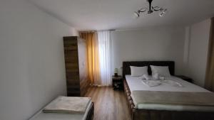 a small bedroom with two beds and a window at Dragobia House & Table in Dragobi