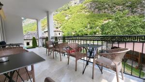 a patio with tables and chairs on a balcony at Dragobia House & Table in Dragobi