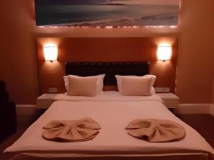 A bed or beds in a room at City Hotel Plovdiv Még 37 kép