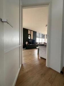 an open door to a room with a living room at City & Nature-Amsterdam NextDoor Free parking 8 person 2 kitchens in Landsmeer +15 photos