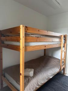 a wooden bunk bed in a room at City & Nature-Amsterdam NextDoor Free parking 8 person 2 kitchens in Landsmeer