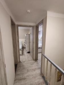 a hallway with a staircase leading to a bedroom at FYRED Vintage Apartman in Tiszafüred
