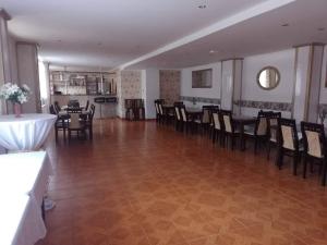 a dining room with tables and chairs and a room with a unintention at Penzion Anna in Hrabušice
