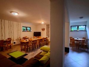 a living room with a couch and a dining room at Dwór Na Otulinie in Białowieża