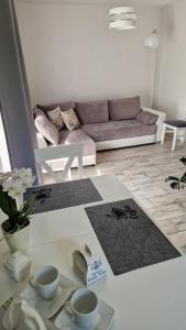 a living room with a couch and a table at Apartament w Krzesznej in Krzeszna
