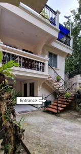 a white house with stairs in front of it at Kayakas Residences 3-bedroom apartment Pagsanjan Townproper in Dingin