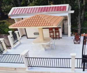 a gazebo with a table and chairs on a patio at Kayakas Residences 3-bedroom apartment Pagsanjan Townproper in Dingin