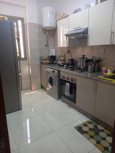 a kitchen with a stove and a washing machine at Tangier Beach Front in Tangier