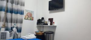 a room with a bed and a tv on a wall at Mar&Mar in Alghero