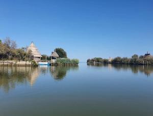 a view of a lake with a temple in the background at Ca'del Porto in Marano Lagunare