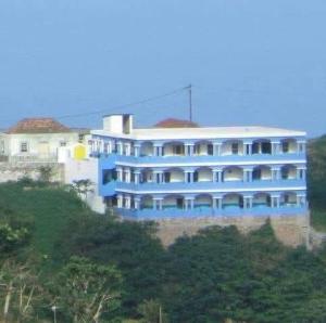 a blue building on top of a hill at Djabraba's Trail in Vila Nova Sintra
