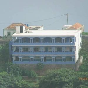 a large blue building on top of a hill at Djabraba's Trail in Vila Nova Sintra
