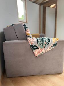 a couch with a blanket on top of it at Helagust in Dołgie