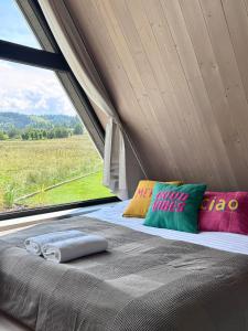 a bed in a tent with a window at Hill House Apartamenty in Białka Tatrzanska +146 photos