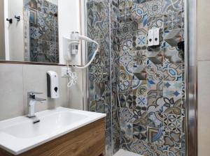 a bathroom with a sink and a shower at Mar&Mar in Alghero