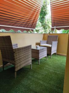 a patio with two chairs and a table and windows at Mar&Mar in Alghero
