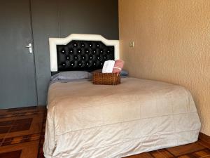 a bedroom with a bed with a basket on it at Apto - Brasilândia do Sul - PR in Assis Chateaubriand